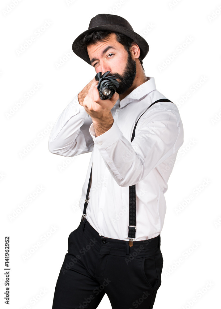 Hipster man with beard holding an umbrella Hipster man with beard holding an umbrella