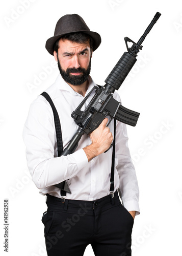 Hipster man with beard holding a rifle