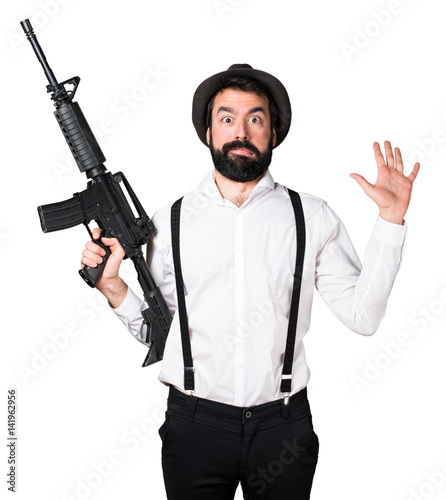 Hipster man with beard holding a rifle