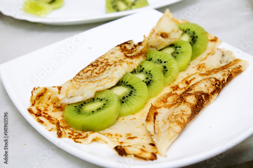 crepes and pancakes with fruit, whipped cream and chocolate