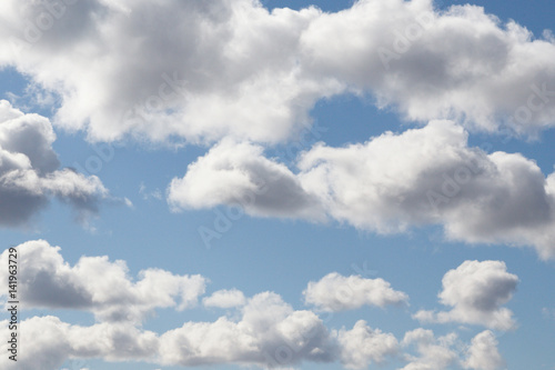 Fluffy clouds under the blue sky float