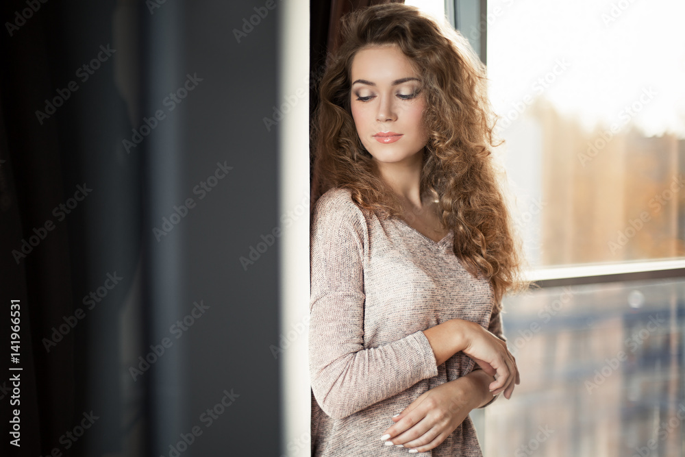 Curly girl at the window Curly girl at the window