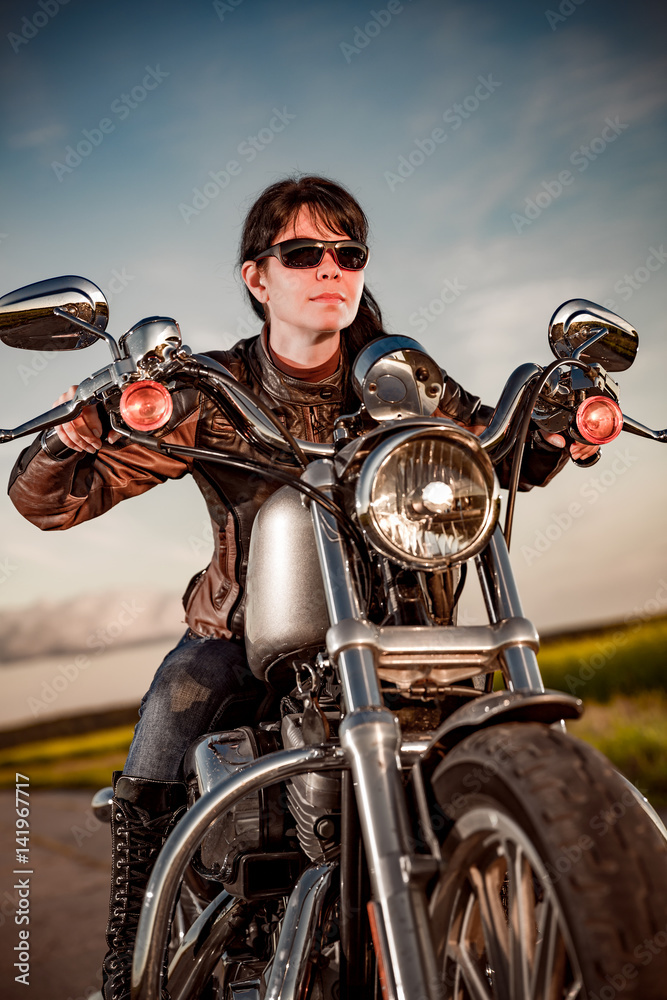 Naklejka premium Biker girl on a motorcycle