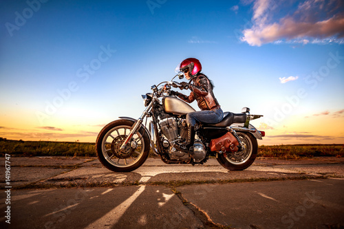 Fototapeta Naklejka Na Ścianę i Meble -  Biker girl on a motorcycle