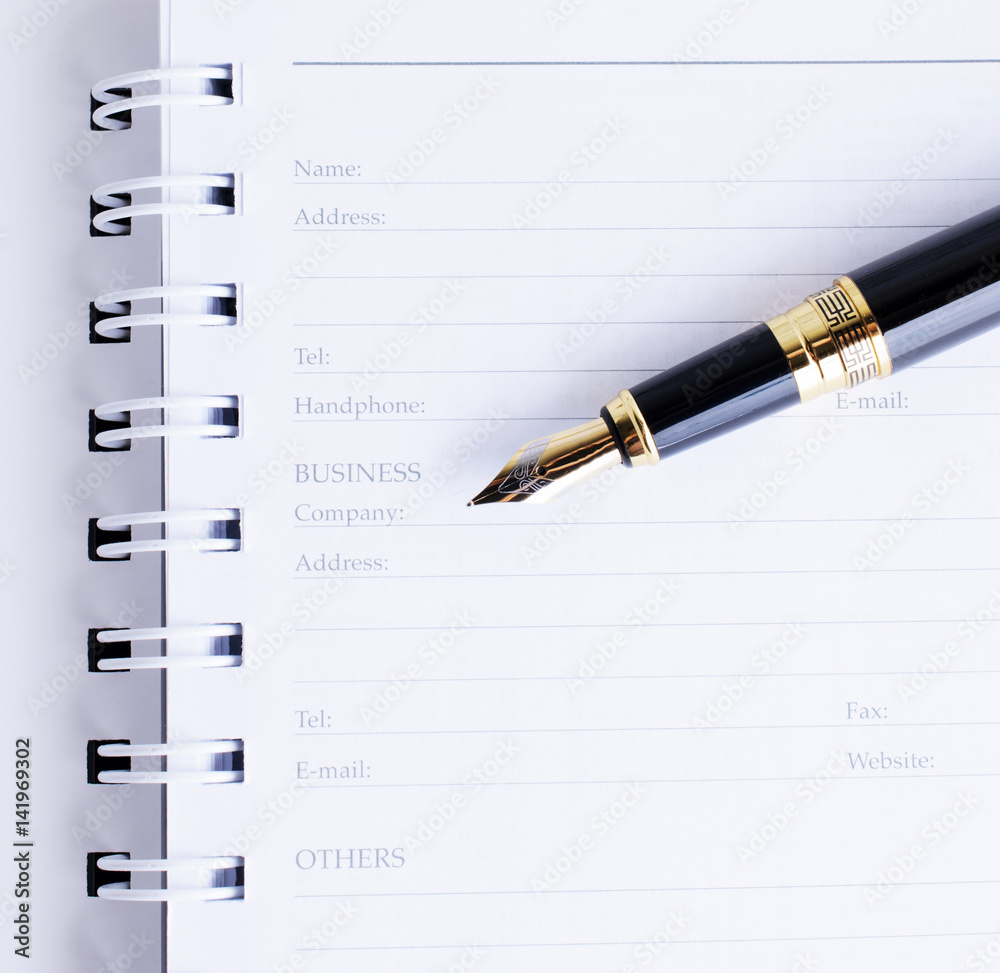 Close up of Fountain pen on Business memory book page Close up of Fountain pen on Business memory book page
