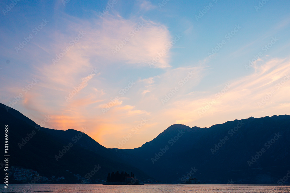 Sunset in the Bay of Kotor. Montenegrin sunsets. Sunset over the sea and the mountains.