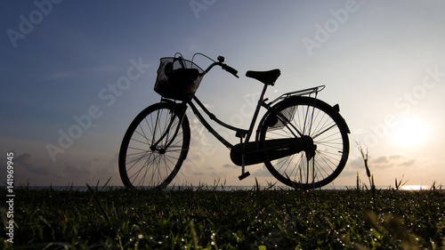 Bicycle beach sunrise silhouette