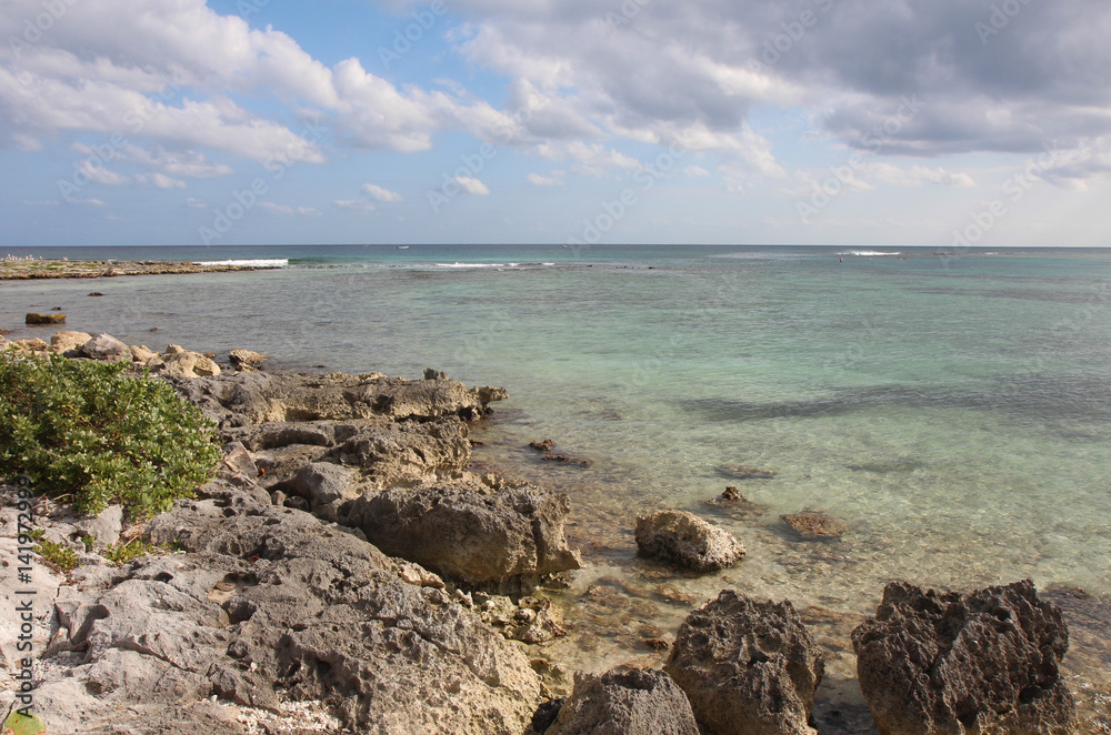 The green wathers of the ocean in sunny weather are washed by stony shore,Mexico The green wathers of the ocean in sunny weather are washed by stony shore,Mexico
