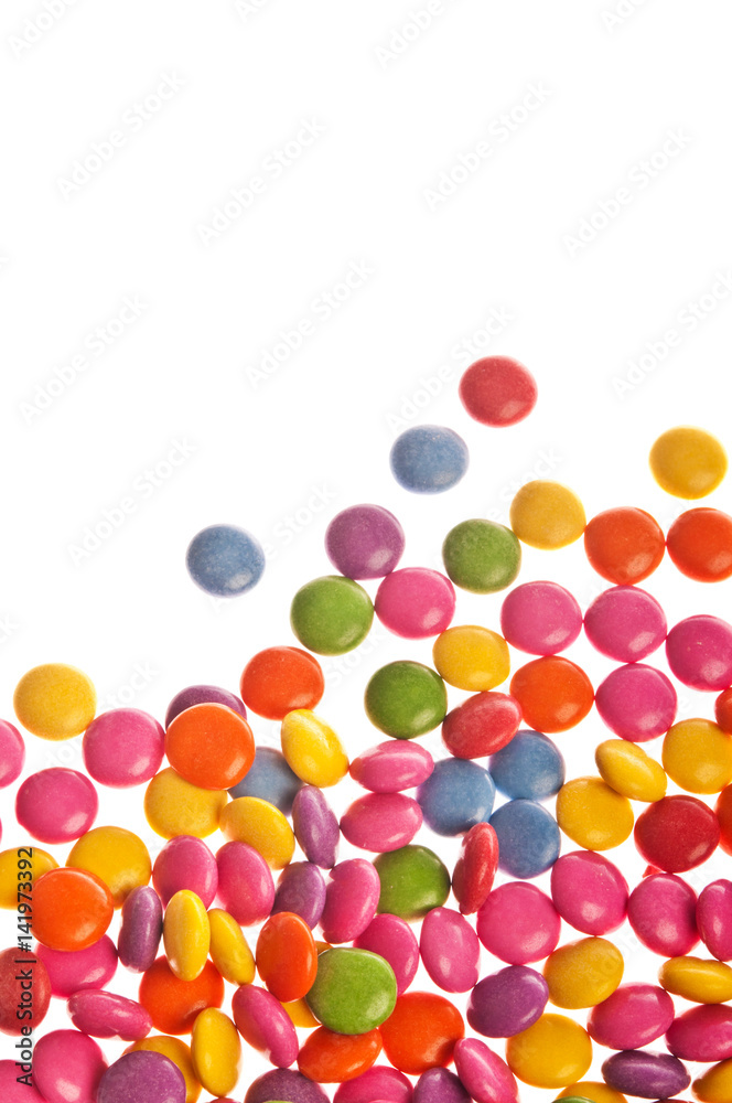 many colorful sugar coated candy, candies over white background 