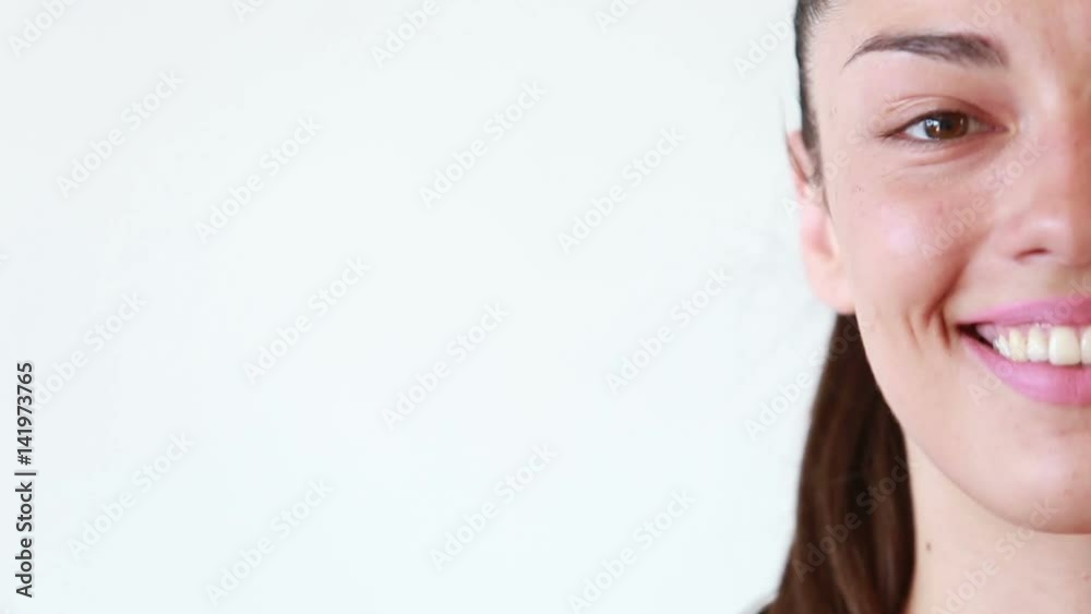 Close up of half face portrait of beautiful smiling woman waving isolated on white background Close up of half face portrait of beautiful smiling woman waving isolated on white background