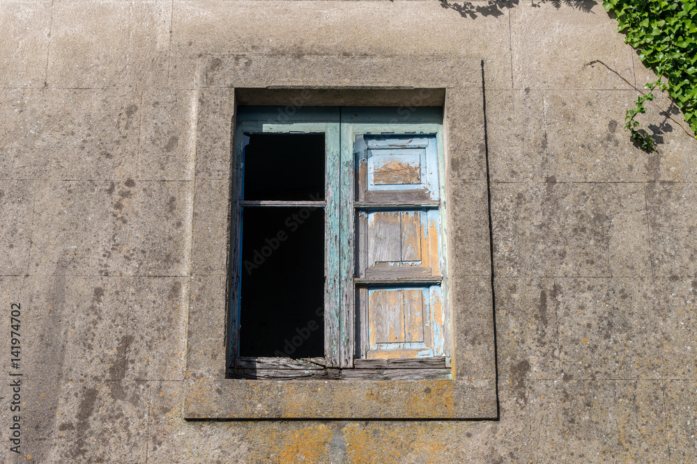 window in the wall of an abandoned house