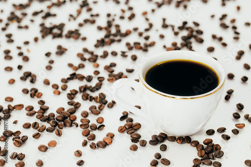 white coffee Cup and coffee beans on white background.