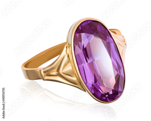 Golden ring with purple gemstone closeup