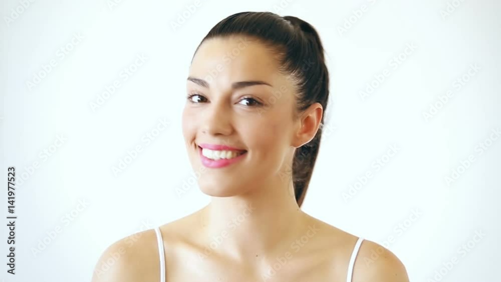 Close up portrait of beautiful woman with makeup smiling and sending kisses to camera Close up portrait of beautiful woman with makeup smiling and sending kisses to camera