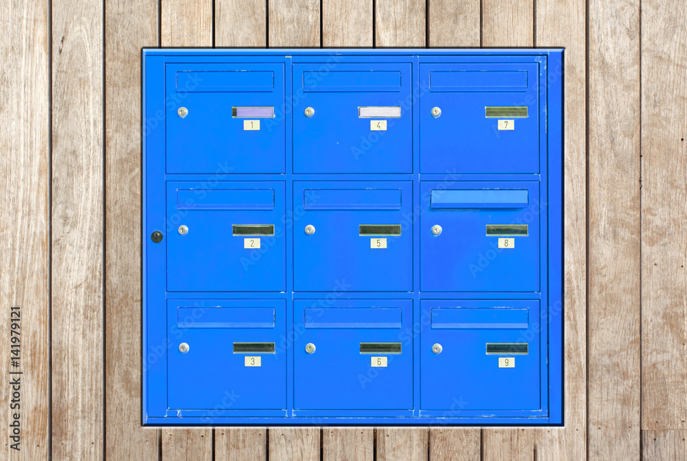 Fototapeta premium boîtes aux lettres bleues incrustées dans panneau de bois