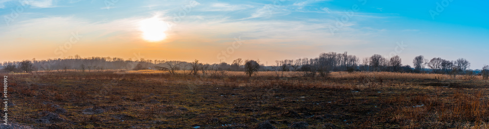 Winter panorama of sunset over a dried landscape