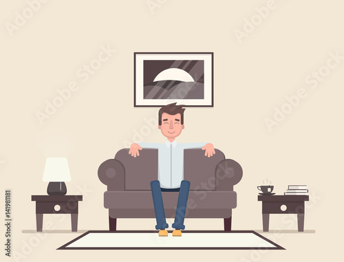 The man is sitting in the room and resting.