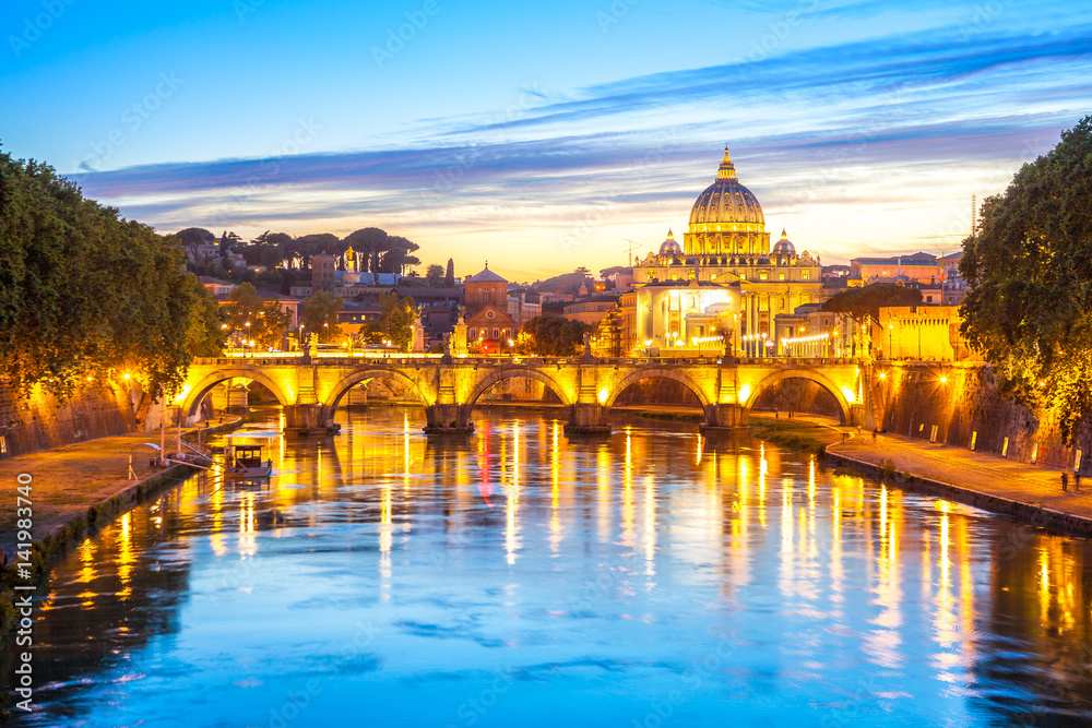 Cityscape of Rome at twilight with San Pietro cathedral, Sant'Angelo bridge and Tevere river illuminated by city lights of Roma in Italy