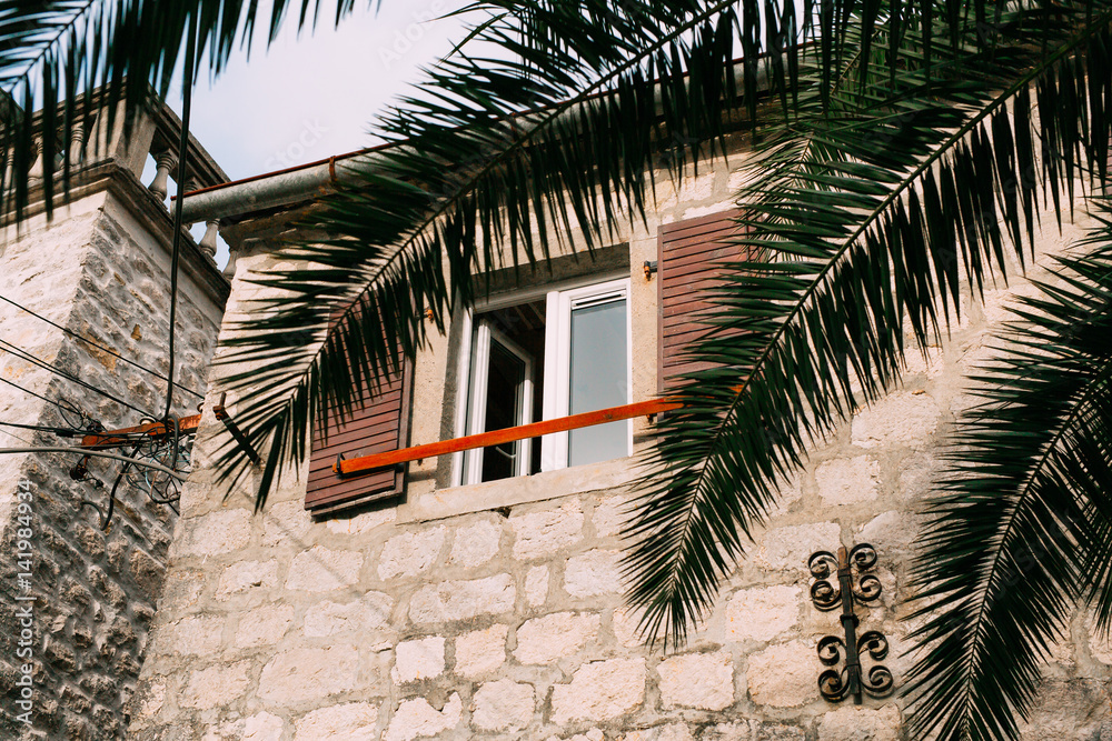 Wooden brown window shutters. The facade of houses in Montenegro.