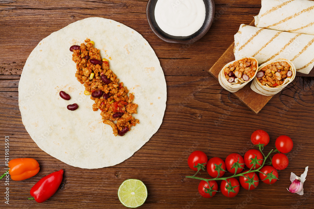 Burritos wraps with meat, beans and vegetables.