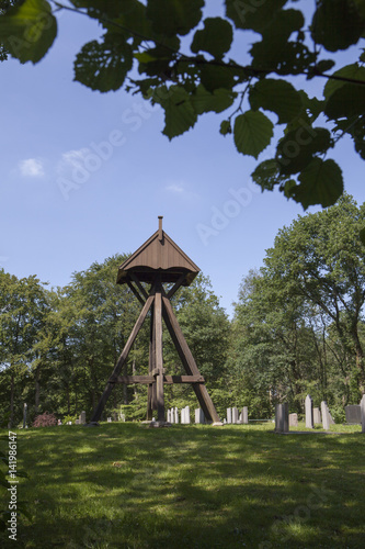 Wooden belfry and cemetry. Oldebercoop Friesland Netherland. Bell chair. photo