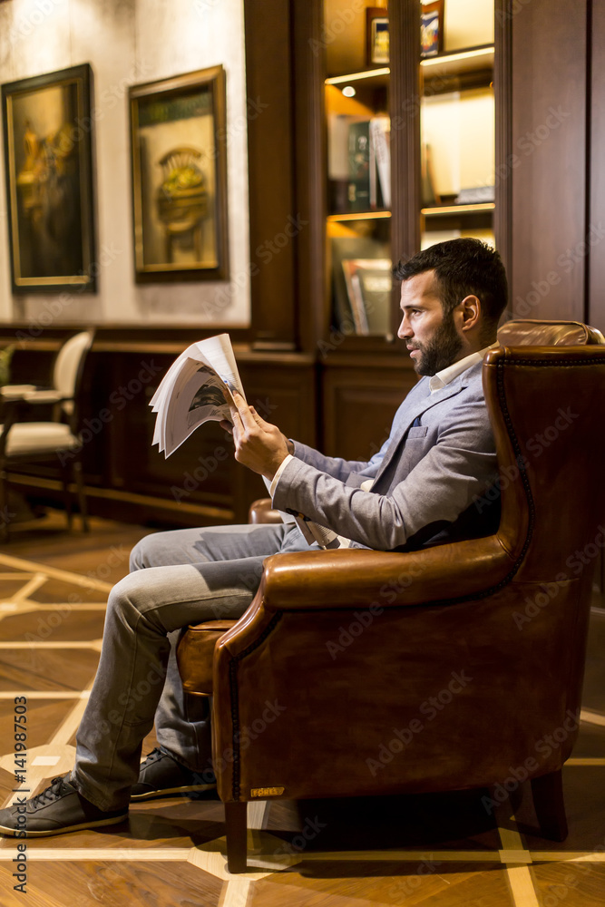 Modern businessman reading newspaper Modern businessman reading newspaper