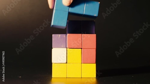 Man's hand picking 3D tetris