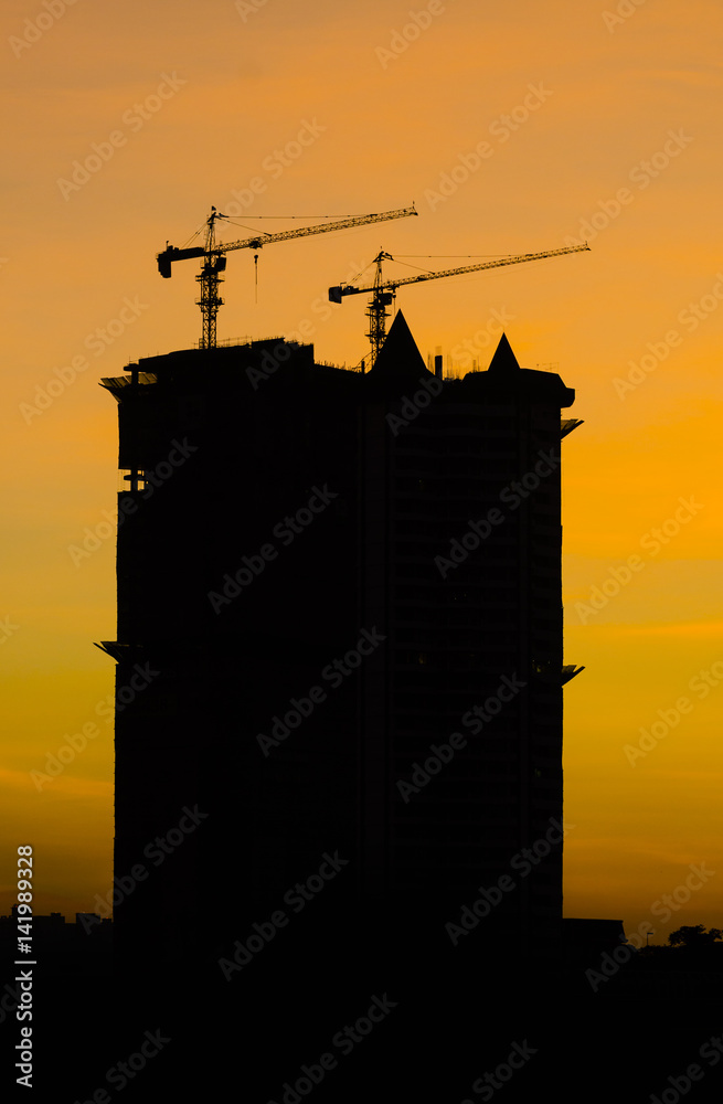 Sunset over the construction crane