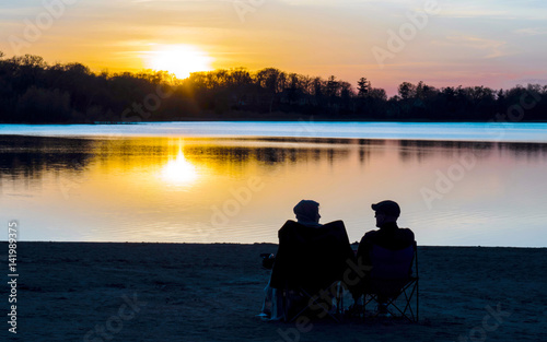 Couple are sitting together to see sunset