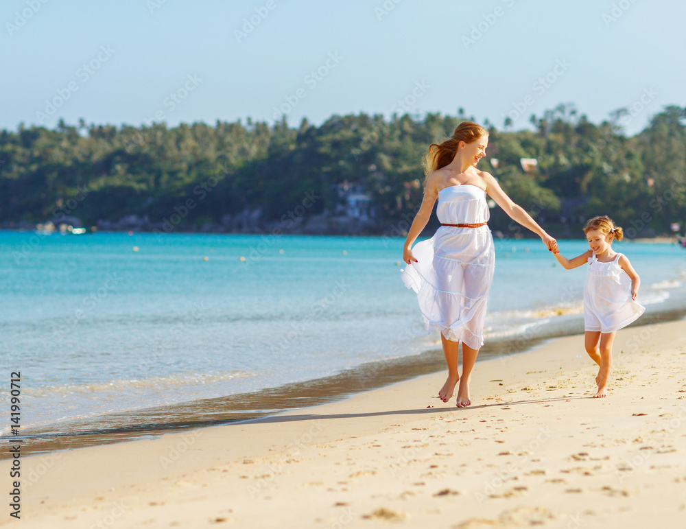 happy family mother and daughter run, laugh and play at beach happy family mother and daughter run, laugh and play at beach