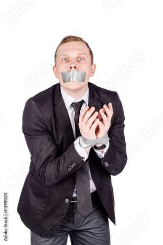 businessman with adhesive tape on his mouth and hands. .