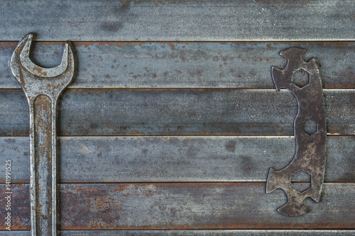Wrenches on an old rusty metal background.