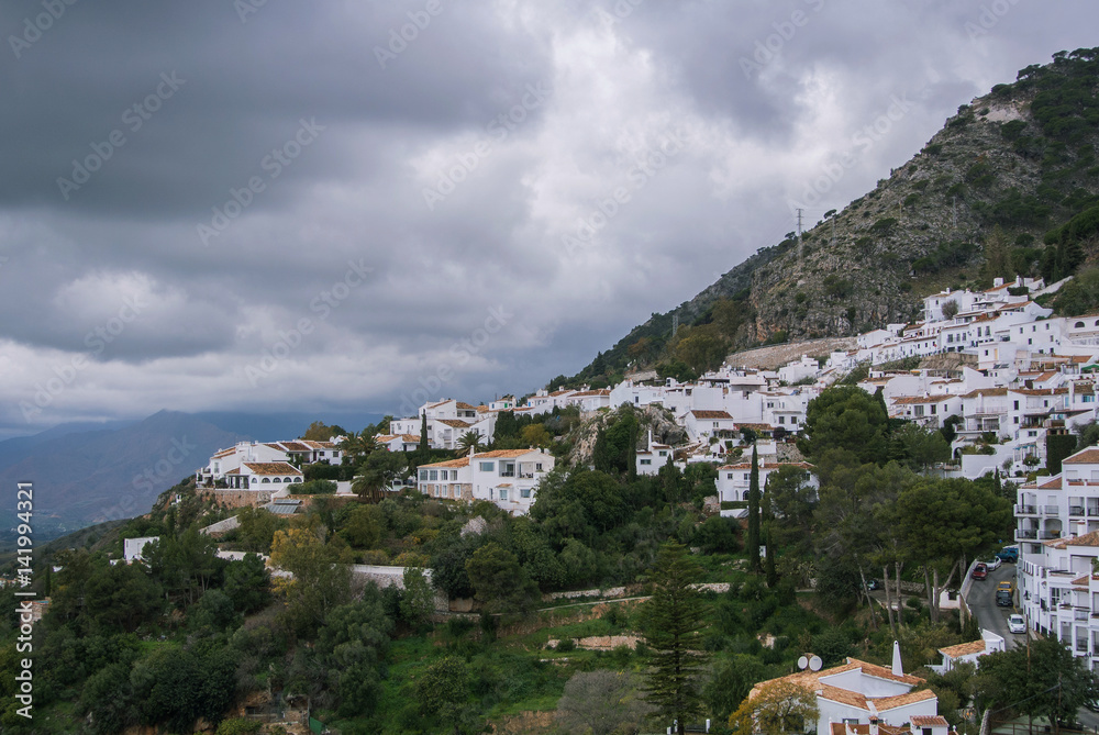 A paroramic view of a mountain and Mijas, a small touristyc white-washed village at Malaga province (Andalusia, Spain) on winter cloudy day. A paroramic view of a mountain and Mijas, a small touristyc white-washed village at Malaga province (Andalusia, Spain) on winter cloudy day.