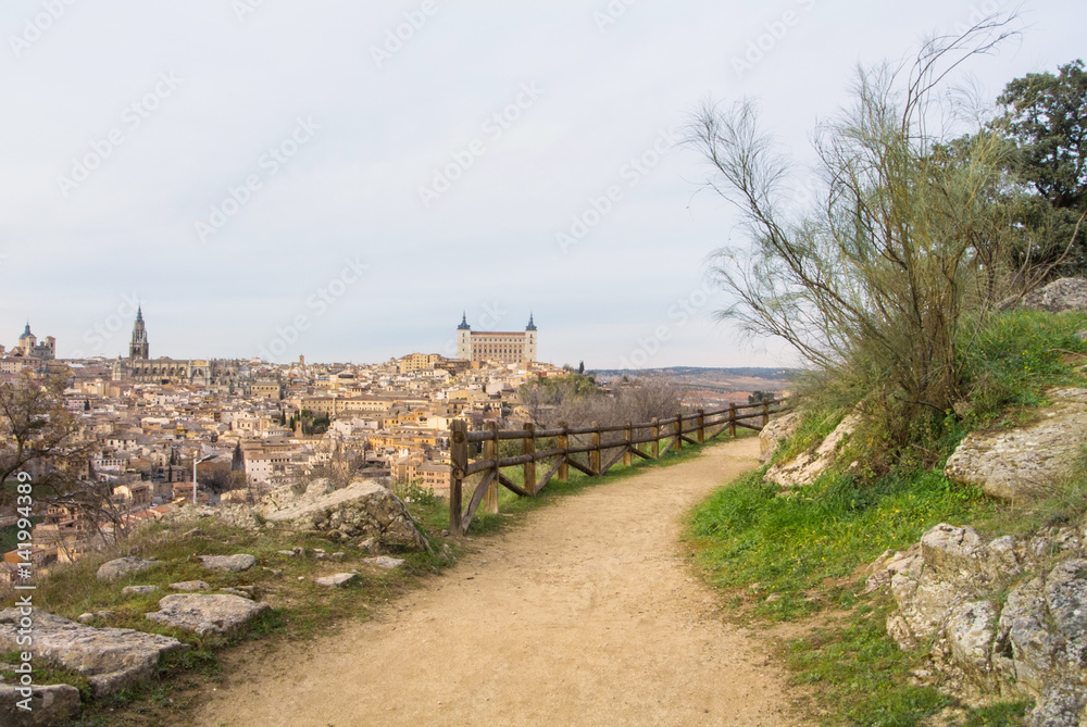 A path over the hill vith a view to Toledo Alcazar, evening at surroundings of Toledo, Castilla la Mancha, Spain.