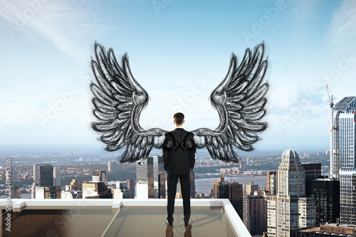 Man with wings on rooftop