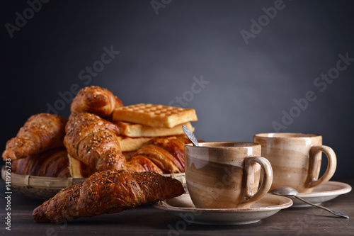 Breakfast with black coffee and fresh pastries