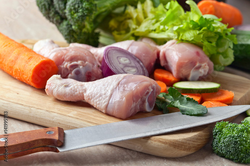 Close-up of chicken drumsticks with vegetables