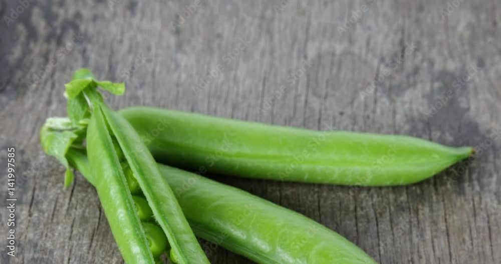 closeup pan of fresh green peas on old wood table, 4k prores footage closeup pan of fresh green peas on old wood table, 4k prores footage