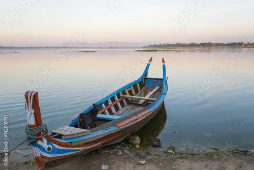 Wooden boat in Ubein Bridge at sunrise  Mandalay  Myanmar  World longest wooden bridge 