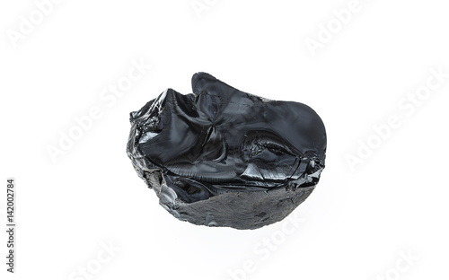 Bitumen, a piece of black resin on a white background