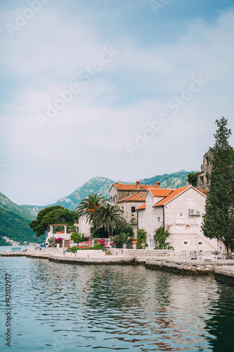 Fototapeta Naklejka Na Ścianę i Meble -  The old town of Perast on the shore of Kotor Bay, Montenegro. The ancient architecture of the Adriatic and the Balkans. Fishermen's cities of Europe.