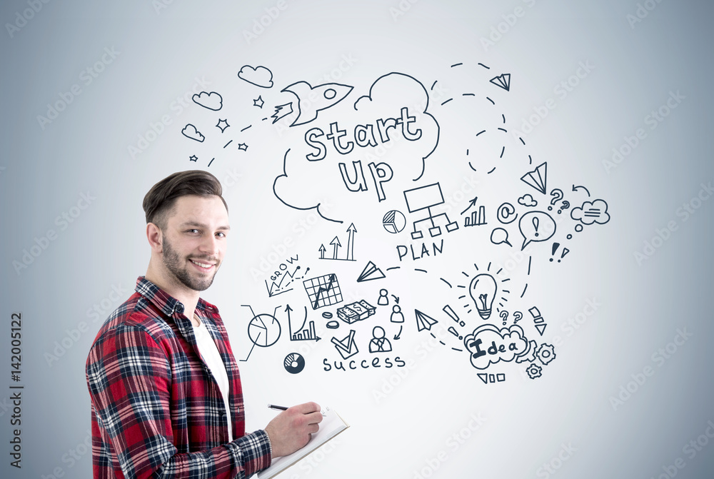 Bearded guy with notebook and start up sketch Bearded guy with notebook and start up sketch
