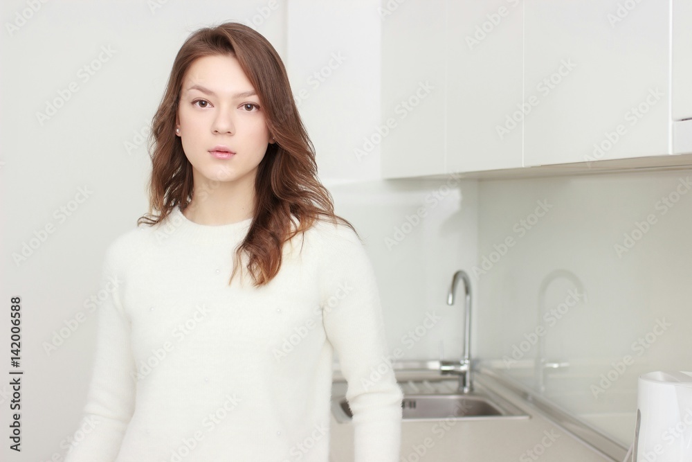 Portrait of smiling young housewife in kitchen Portrait of smiling young housewife in kitchen