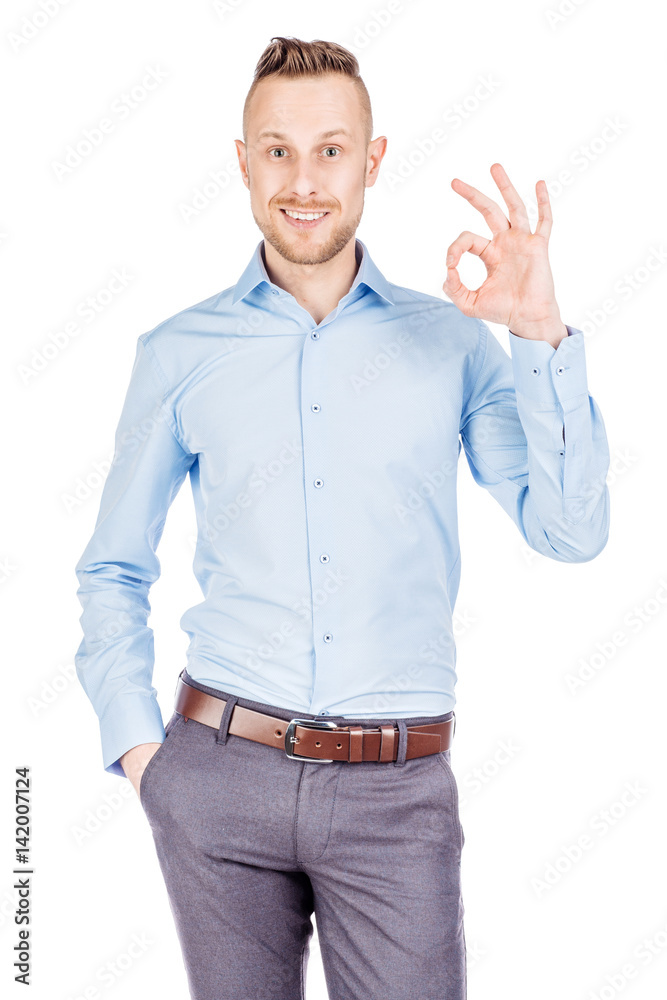 businessman showing OK while standing against white background