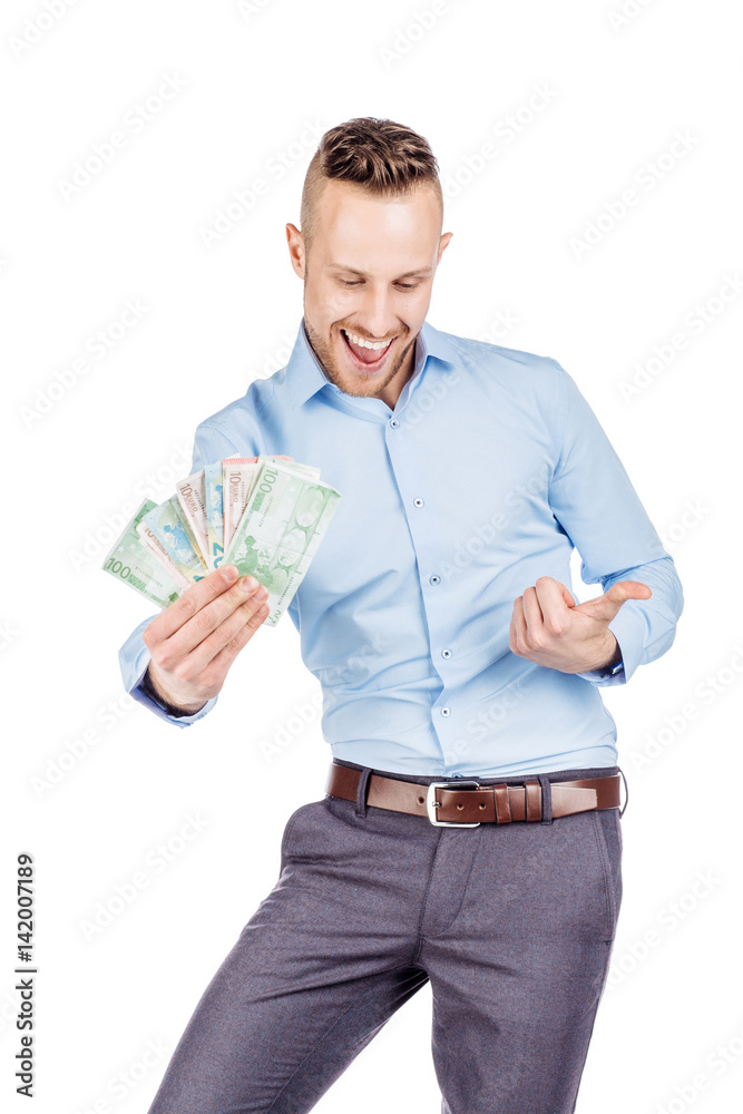 portrait of young businessman holding and counts money dollar bills in hands, isolated on white background. emotion facial expression feeling. financial reward savings portrait of young businessman holding and counts money dollar bills in hands, isolated on white background. emotion facial expression feeling. financial reward savings