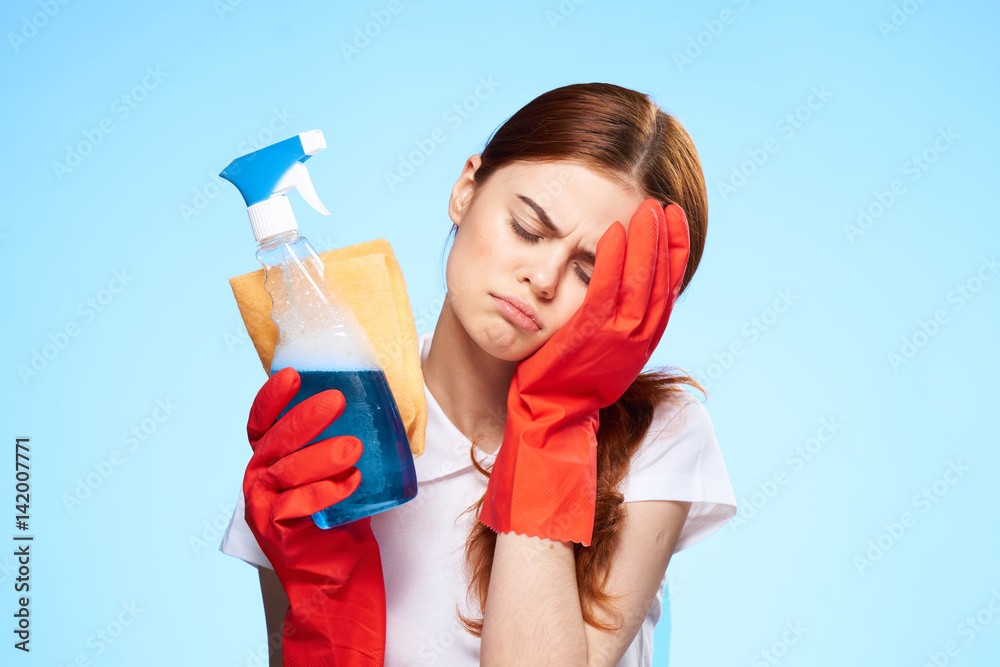 tired woman with a cleanser and a rag, headache tired woman with a cleanser and a rag, headache