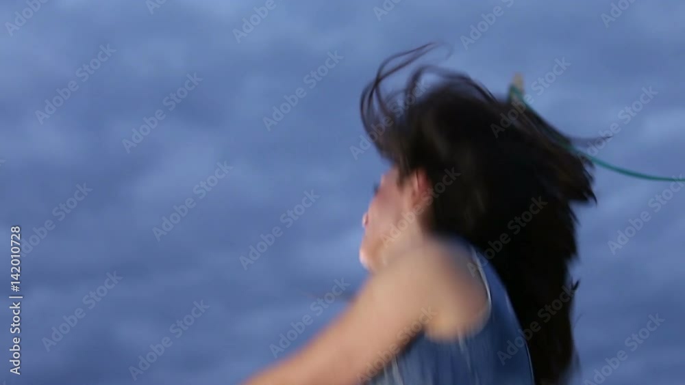Low angle shot of beautiful brunette woman jumping with firework candle on the rooftop terrace, slow motion Low angle shot of beautiful brunette woman jumping with firework candle on the rooftop terrace, slow motion