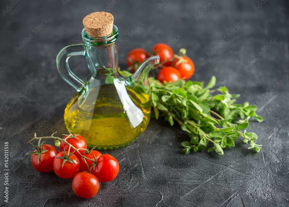 Bottle with vegetable oil and cherry tomatoes Bottle with vegetable oil and cherry tomatoes