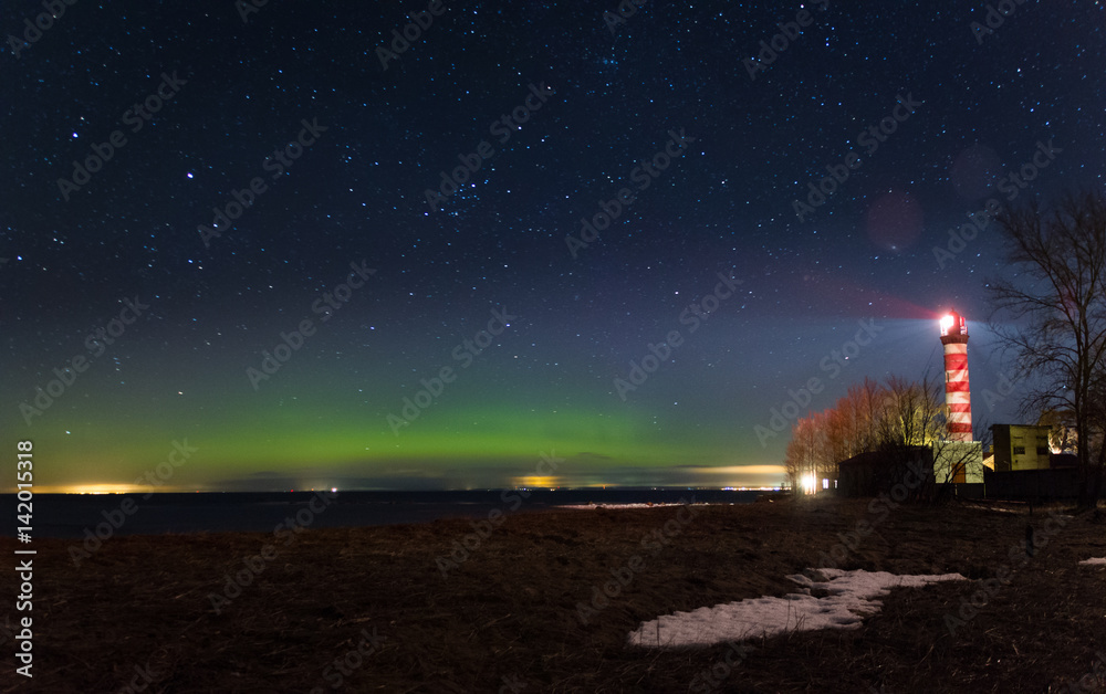 Aurora borealis. Lighthouse at night. Ladoga