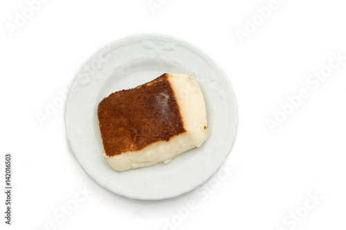 Kazandibi (surface burnt pudding) dessert on white background high angle view photo